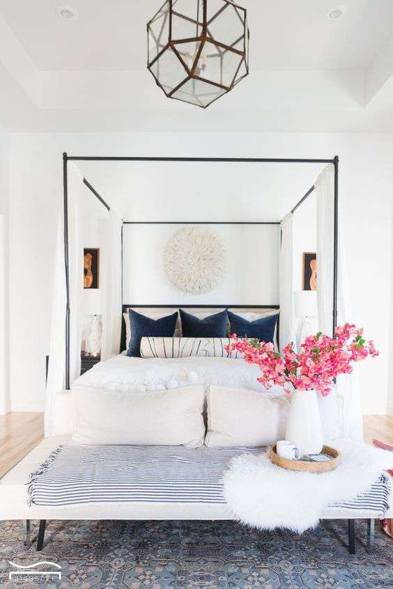 throw pillows and pink flowers improve the color landscape of this room on a budget