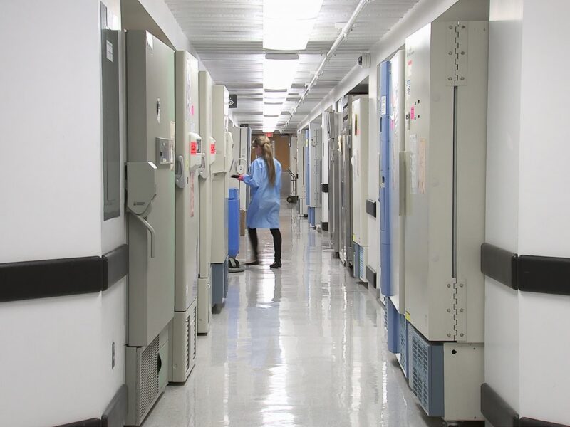 man in blue dress shirt walking on hallway